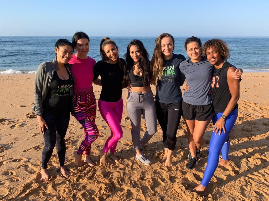 Women gathered on the beach during a sister retreat in Portugal